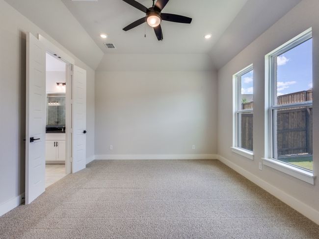 Your dreamy new owner's suite features oversized windows, high ceilings and plush carpeting all in a neutral color palette. | Image 12