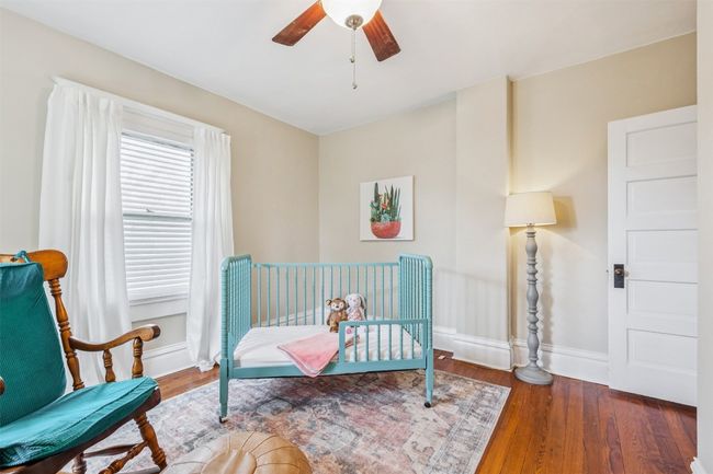 Bedroom with wood finished floors and a ceiling fan | Image 25