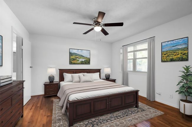 Bedroom with dark wood-type flooring, baseboards, and ceiling fan | Image 30
