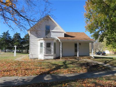 Bungalow-style home with a porch and a front lawn | Image 1