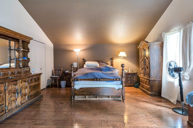 Bedroom featuring hardwood / wood-style floors and lofted ceiling | Image 24