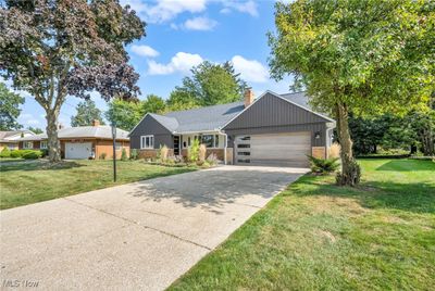 Ranch-style home with a front yard and a garage | Image 3