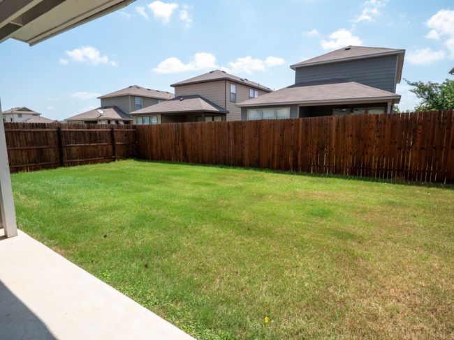 View of fenced backyard | Image 18