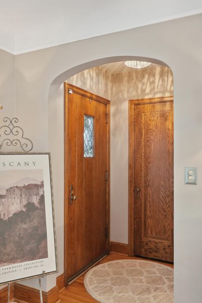 The entryway welcomes you with a stunning chandelier and graceful archways. | Image 3