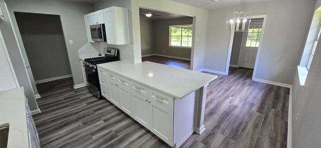 Another view from the kitchen to the dining and living room | Image 7