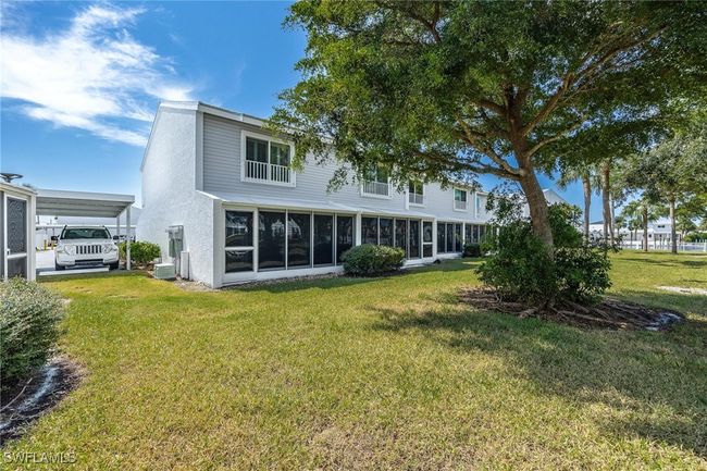 Back of property with a enclosed lanai. | Image 36