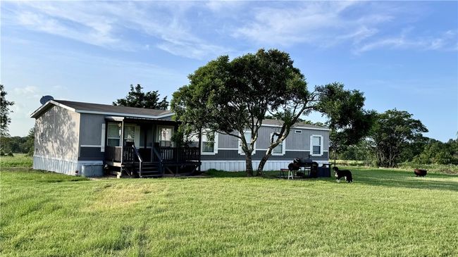 Back of house with a porch and a lawn | Image 6