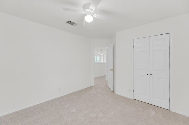 Unfurnished bedroom with baseboards, light carpet, visible vents, and a closet | Image 29