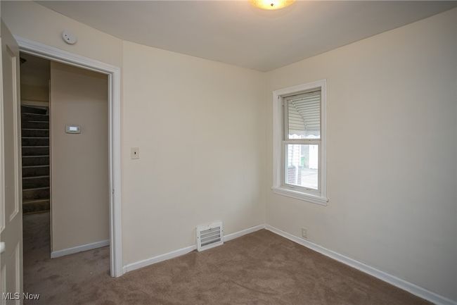 Unfurnished room with dark carpet and a smoke detector | Image 14