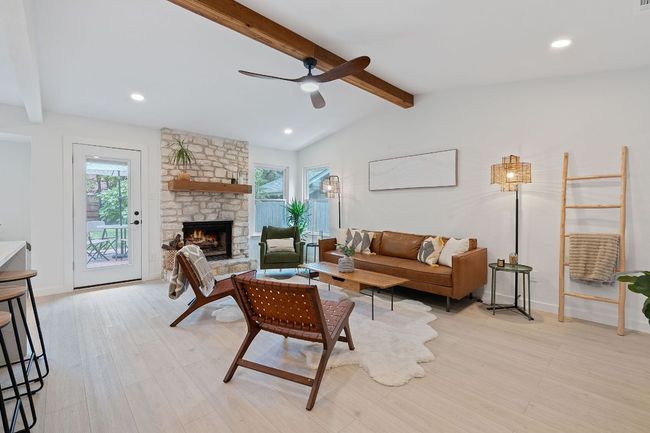 Living area with ceiling fan, a fireplace, light wood-type flooring, and recessed lighting | Image 5