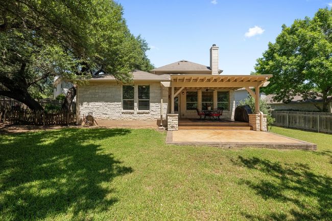 Back of house featuring a patio area, and stone siding | Image 29