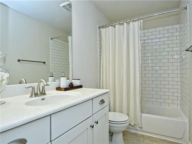 Bathroom featuring vanity, tile patterned flooring, and shower / bath combo | Image 17