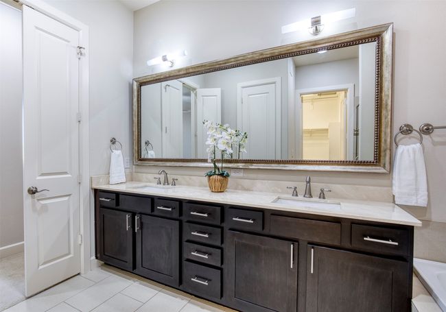 En-suite bath with dual sinks and framed mirror. | Image 19