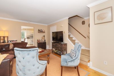 Enter into a warm living room space with coat closet and hardwood floors | Image 3