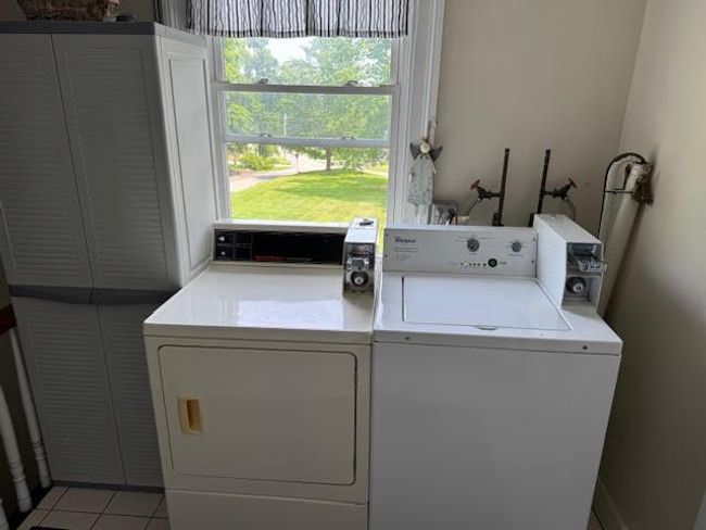 Washroom featuring washer and clothes dryer and light tile patterned flooring | Image 33