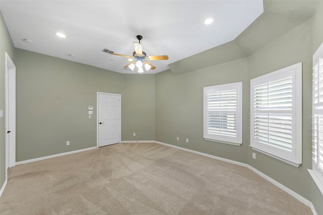 Empty room featuring light carpet, ceiling fan, baseboards, plenty of natural light, and recessed lighting | Image 22