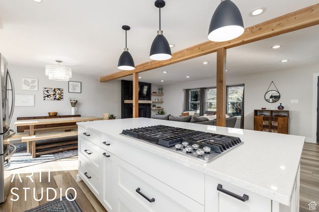 Kitchen featuring appliances with stainless steel finishes, light wood-style flooring, light stone countertops, and recessed lighting | Image 9