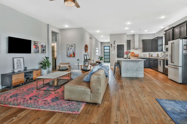 Living area with a ceiling fan, light wood-style flooring, and recessed lighting | Image 14