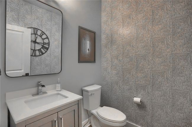 Beautiful custom built in pantry cabinets. Hardwood staircases leading to second floor. | Image 19