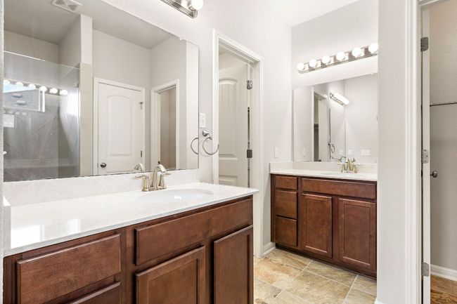 Bathroom featuring vanity, visible vents, and tiled shower | Image 18