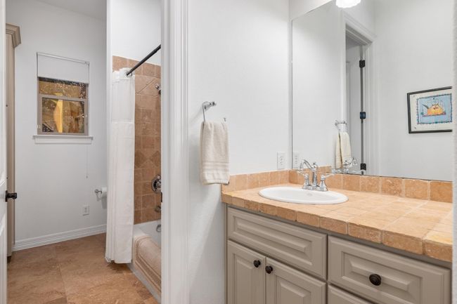 Bathroom with vanity and shower / tub combo with curtain | Image 27