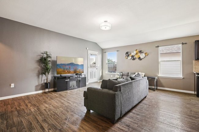 Living area featuring lofted ceiling and dark wood-style flooring | Image 14