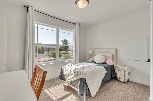 Bedroom featuring light colored carpet and baseboards | Image 17