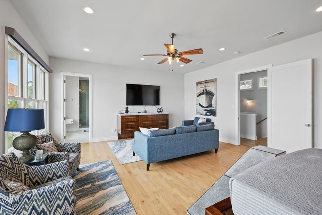 Living room featuring light wood finished floors, recessed lighting, a ceiling fan, baseboards, and visible vents | Image 32