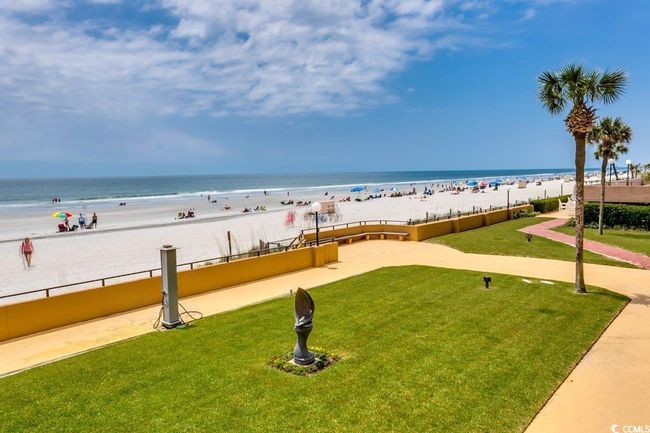 View of property's community featuring a lawn, a water view, and a beach view | Image 24