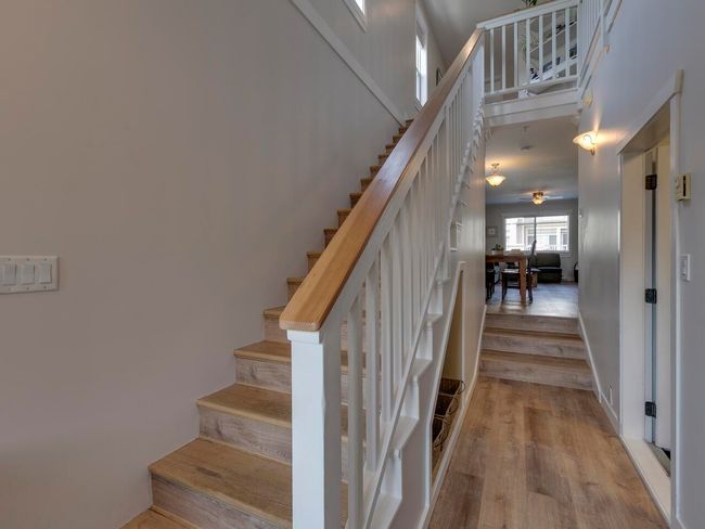 Stairway featuring wood finished floors and ceiling fan | Image 4