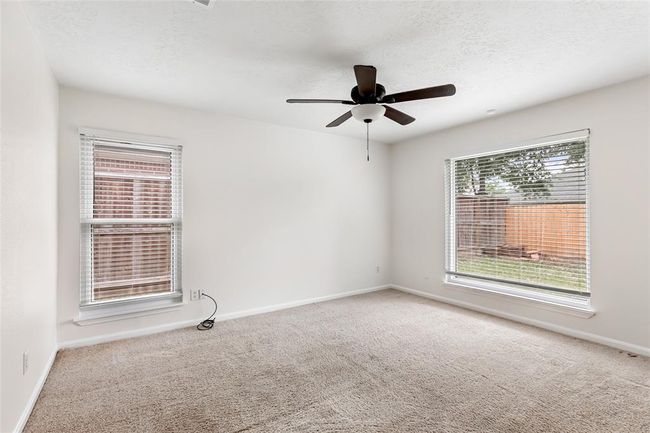 Ceiling fans in both bedrooms and living room. | Image 17