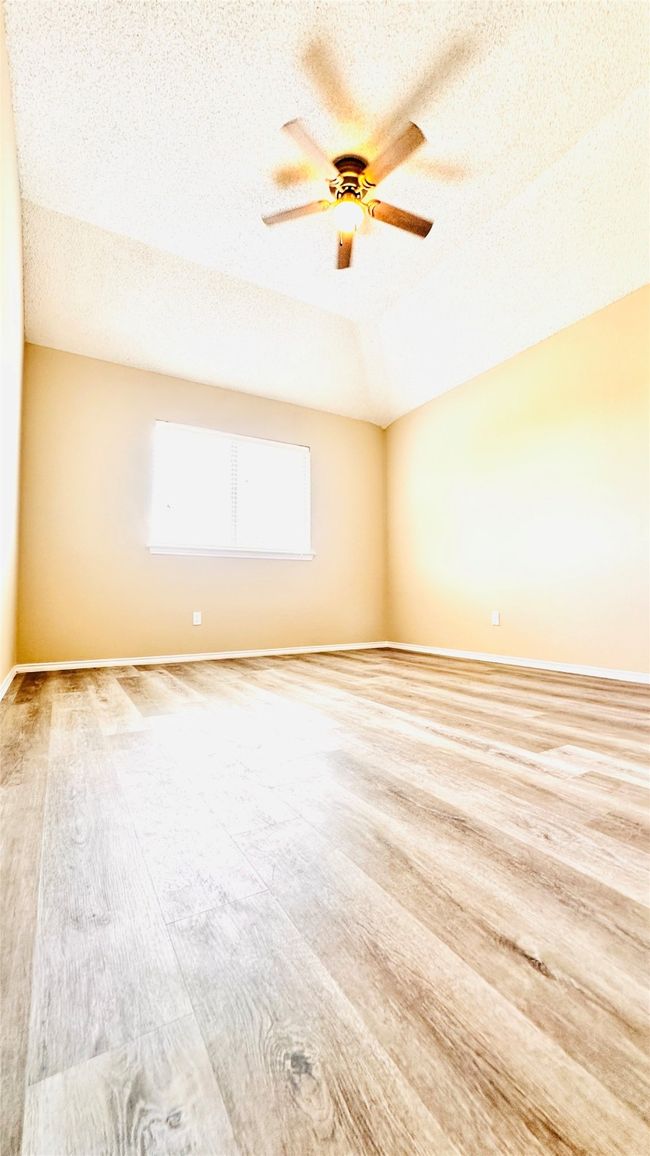 Spare room with ceiling fan, a textured ceiling | Image 8