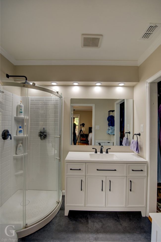 Full bath featuring a stall shower, visible vents, connected bathroom, and vanity | Image 19