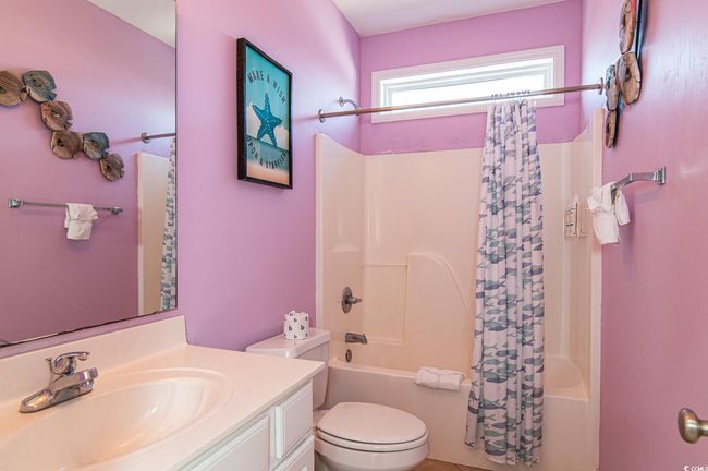 Bathroom with shower / tub combo with curtain, toilet, and vanity | Image 17