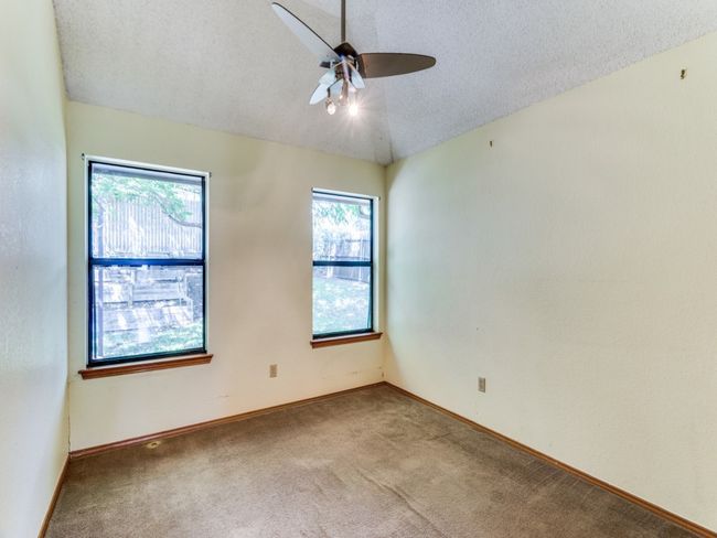 Spare room featuring a ceiling fan, carpet flooring, and a textured ceiling | Image 16