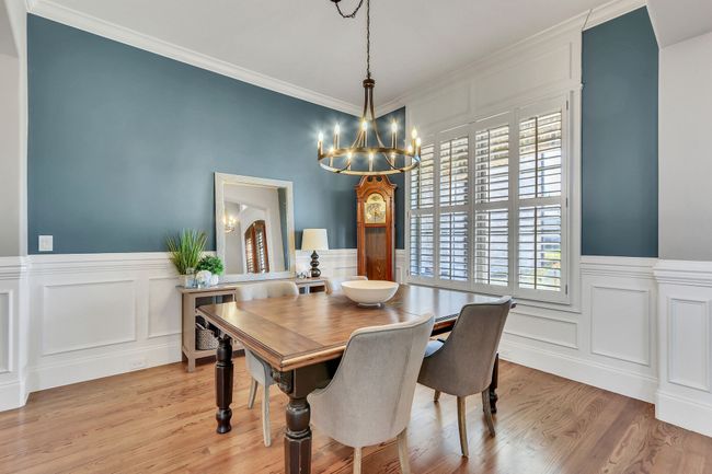 The formal dining room can accommodate a crowd. Notice the millwork details around the walls and windows. | Image 25