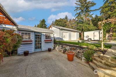 Fantastic back yard with koi pond, tool shed and two car garage. | Image 3