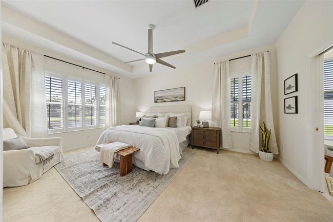 Spacious primary suite overlooking pool and pond. | Image 33