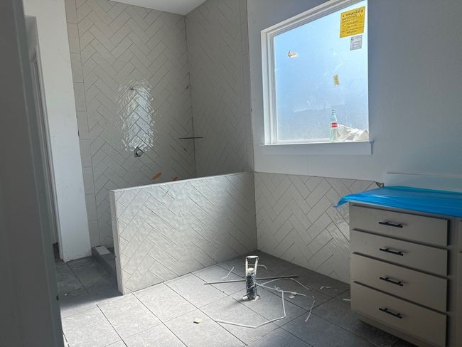 Full bath featuring tile walls, walk in shower, and tile patterned flooring | Image 5