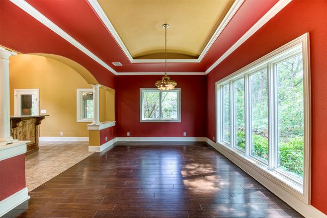 Dining room with trey ceiling overlooking the front of the estate. | Image 9