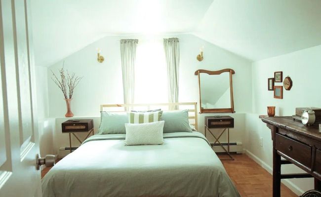Bedroom with light parquet flooring, vaulted ceiling, and a baseboard heating unit | Image 13
