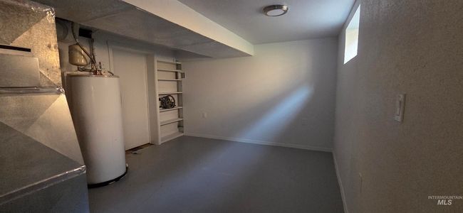 Below grade area with gas water heater and baseboards | Image 16