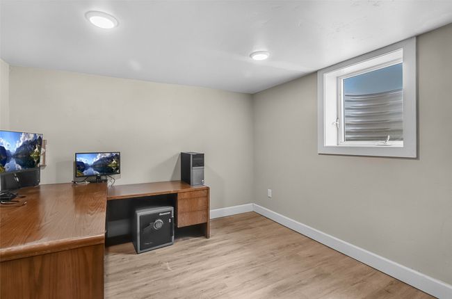 Unfurnished office with light wood-type flooring and baseboards | Image 26