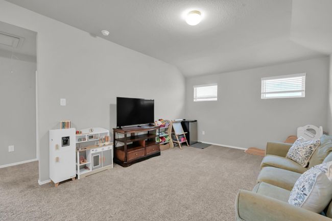 Upstairs, you'll find a generously sized game room with elevated ceilings. | Image 23