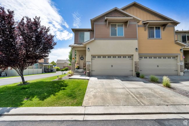 View of front of property with stone siding, an attached garage, and a front lawn | Image 26