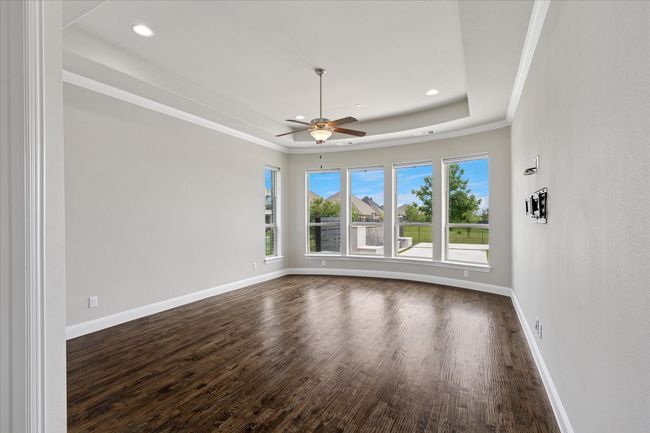 Beautiful master bedroom with wall of windows and tray ceiling | Image 19