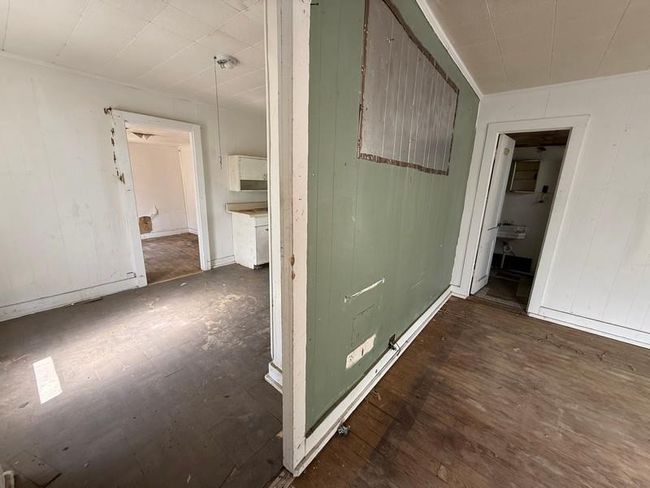 Spare room with wood walls and wood finished floors | Image 14