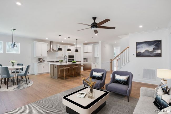 VIRTUAL STAGING. Photo represents the plan with virtual staging. A spacious kitchen with an island and pantry open to an adjoining dining area and the family room. | Image 15