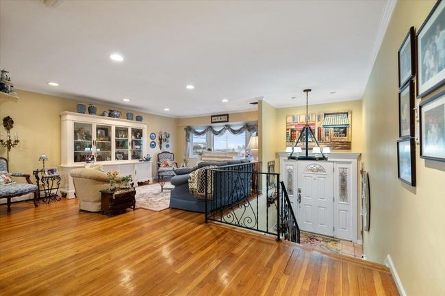 Living room featuring recessed lighting, baseboards, ornamental molding, and light wood finished floors | Image 6
