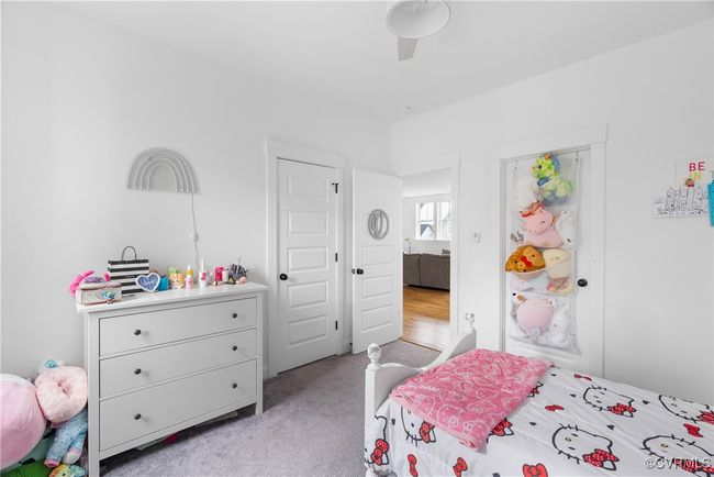 Bedroom featuring light colored carpet and ceiling fan | Image 30